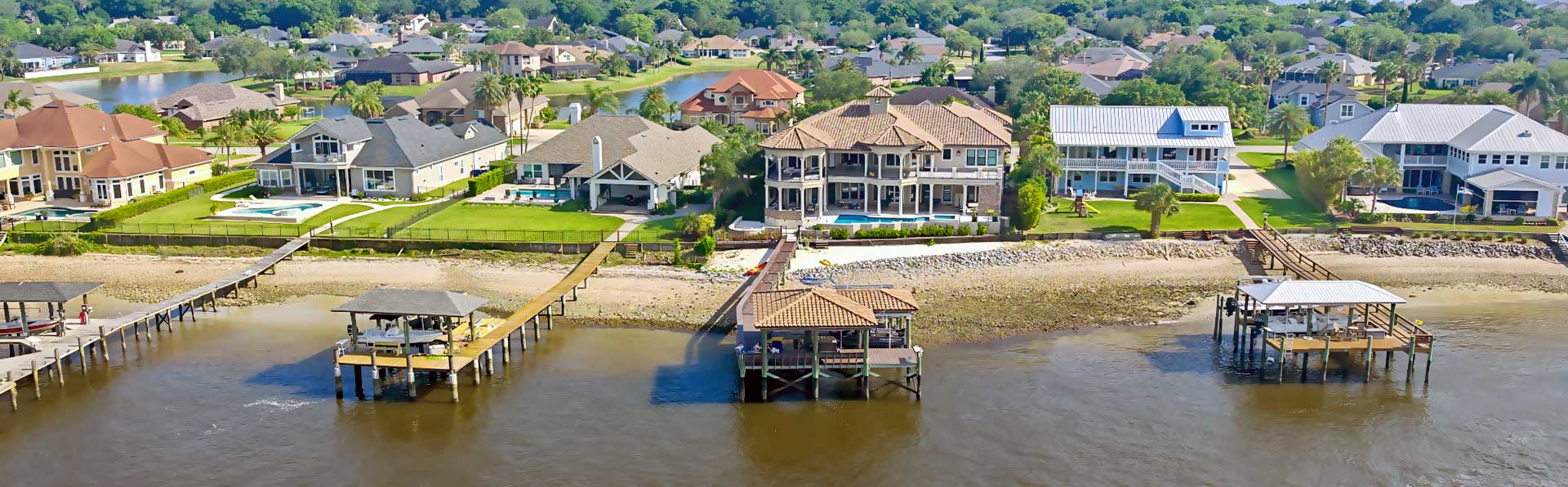 upscale two story homes on the st. johns river with bright color roofs