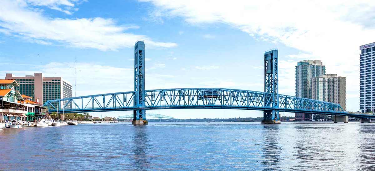 Large blue colored bridge spanning the St Johns river in Jacksonville, FL