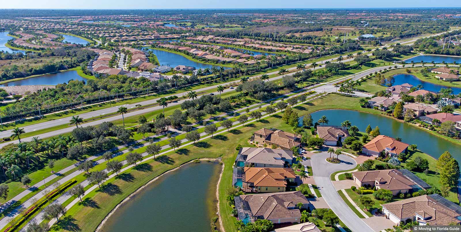 aerial view of large florida homes with tile roofs and water views